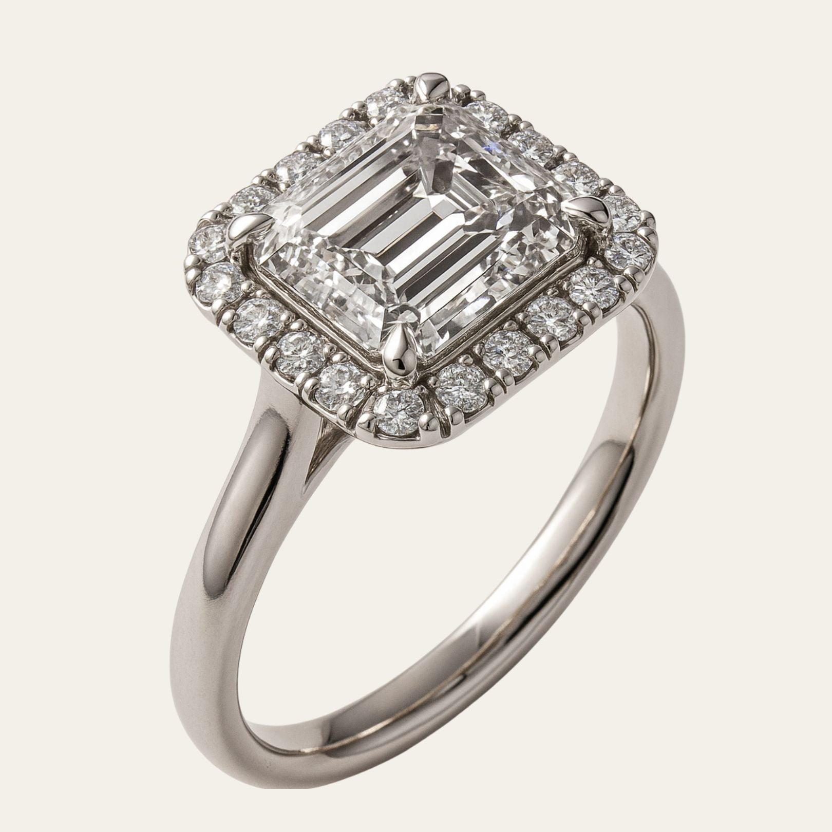 white gold engagement ring, emerald cut diamond ring, halo engagement ring, handmade wedding ring, ethical diamond ring, modern bridal jewelry, geometric engagement ring, handcrafted England ring, sustainable wedding band, anniversary gift, luxury engagement ring, contemporary bridal ring, elegant diamond ring