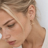 Shop T Bar Half Hoop Stud Earrings in gold vermeil or sterling silver. Minimal, handmade and perfect for everyday wear or layering. Free UK delivery over £75.
