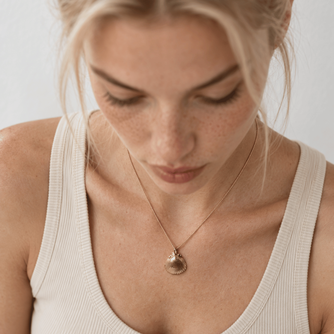 Solid Gold Seashell Necklace for Lovers of the Sea - Dainty London gold seashell necklace, coastal jewelry, ocean pendant, nature inspired jewelry, Cornwall seaside gift, beach lover gift, mermaid jewelry, ocean lover necklace, handmade coastal jewelry, star charm necklace, sustainable jewelry, beach cottage style, meaningful coastal gift