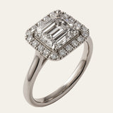 white gold engagement ring, emerald cut diamond ring, halo engagement ring, handmade wedding ring, ethical diamond ring, modern bridal jewelry, geometric engagement ring, handcrafted England ring, sustainable wedding band, anniversary gift, luxury engagement ring, contemporary bridal ring, elegant diamond ring
