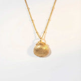 Solid Gold Seashell Necklace for Lovers of the Sea - Dainty London gold seashell necklace, coastal jewelry, ocean pendant, nature inspired jewelry, Cornwall seaside gift, beach lover gift, mermaid jewelry, ocean lover necklace, handmade coastal jewelry, star charm necklace, sustainable jewelry, beach cottage style, meaningful coastal gift