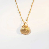 Solid Gold Seashell Necklace for Lovers of the Sea - Dainty London gold seashell necklace, coastal jewelry, ocean pendant, nature inspired jewelry, Cornwall seaside gift, beach lover gift, mermaid jewelry, ocean lover necklace, handmade coastal jewelry, star charm necklace, sustainable jewelry, beach cottage style, meaningful coastal gift