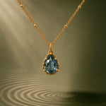 blue topaz necklace, vermeil gemstone jewellery, elegant pendant gift, special occasion jewellery, sterling silver necklace, gift for her, boho style necklace, engagement jewelry, handcrafted gemstone pendant, water-inspired jewelry, dainty topaz necklace, anniversary gift ideas, unique silver jewelry