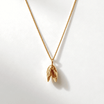 Solid 9ct yellow gold mussel seashell necklace with 1.5cm pendant on an 18 inch chain, handcrafted coastal fine jewellery by Dainty London