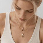 Solid 9ct yellow gold mussel seashell necklace with 1.5cm pendant on an 18 inch chain, handcrafted coastal fine jewellery by Dainty London