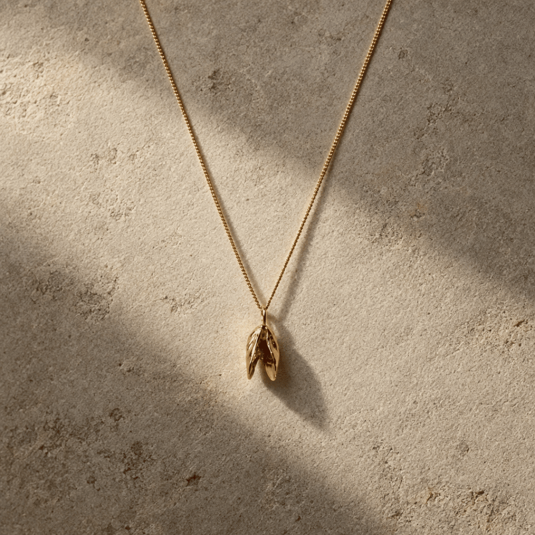 Solid 9ct yellow gold mussel seashell necklace with 1.5cm pendant on an 18 inch chain, handcrafted coastal fine jewellery by Dainty London