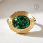 Sylvie solid 9ct gold green emerald ring with 10x8mm oval cut stone and granulation detail, handcrafted luxury fine jewellery by Dainty London

