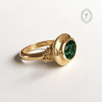 Sylvie solid 9ct gold green emerald ring with 10x8mm oval cut stone and granulation detail, handcrafted luxury fine jewellery by Dainty London