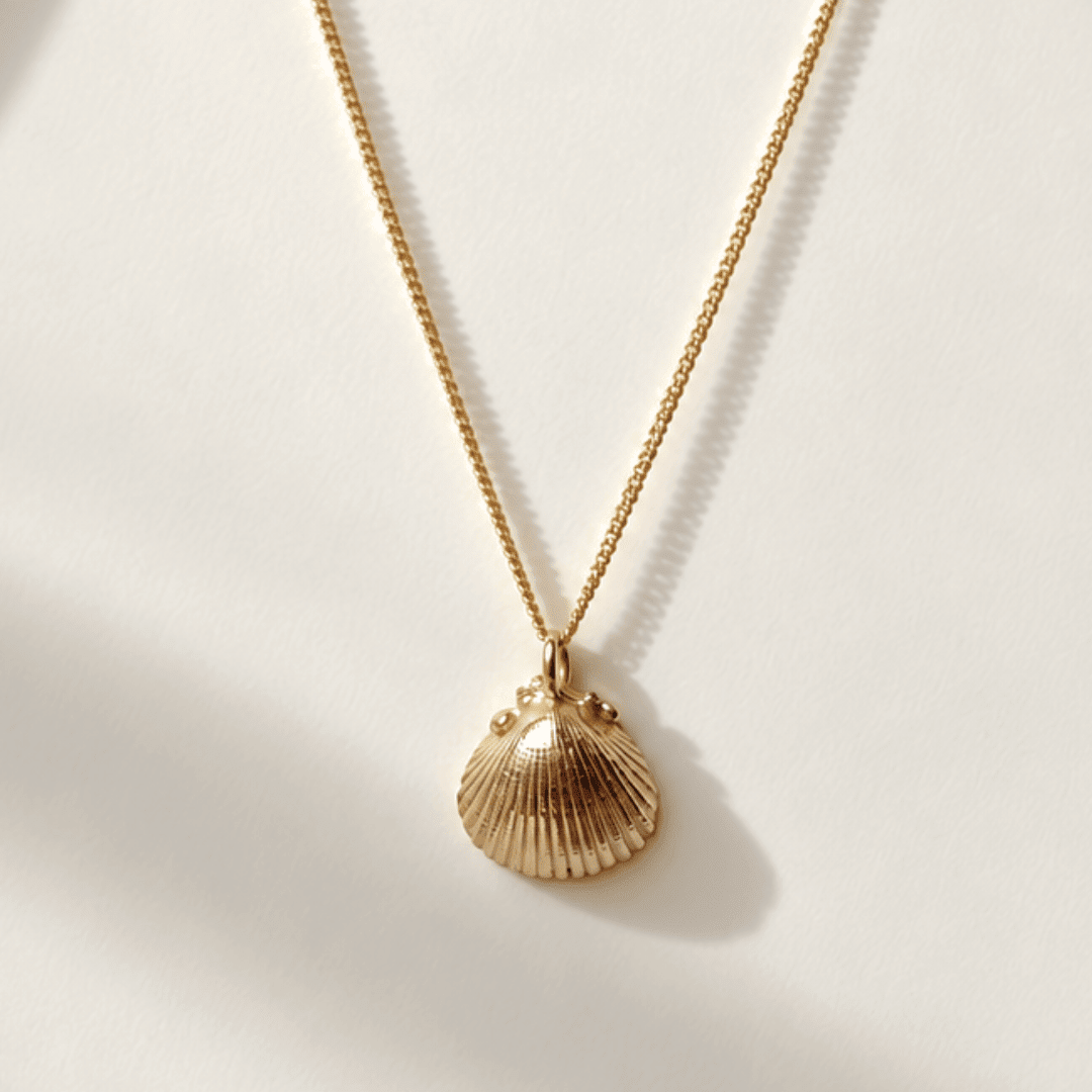 Solid Gold Seashell Necklace for Lovers of the Sea - Dainty London gold seashell necklace, coastal jewelry, ocean pendant, nature inspired jewelry, Cornwall seaside gift, beach lover gift, mermaid jewelry, ocean lover necklace, handmade coastal jewelry, star charm necklace, sustainable jewelry, beach cottage style, meaningful coastal gift