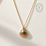 Solid Gold Seashell Necklace for Lovers of the Sea - Dainty London gold seashell necklace, coastal jewelry, ocean pendant, nature inspired jewelry, Cornwall seaside gift, beach lover gift, mermaid jewelry, ocean lover necklace, handmade coastal jewelry, star charm necklace, sustainable jewelry, beach cottage style, meaningful coastal gift