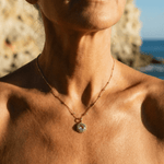 Sunburst necklace with a glowing light purple amethyst, barnacle-textured bezel detail. Ocean-inspired statement jewellery. Selfridges Style Birthday Gifts