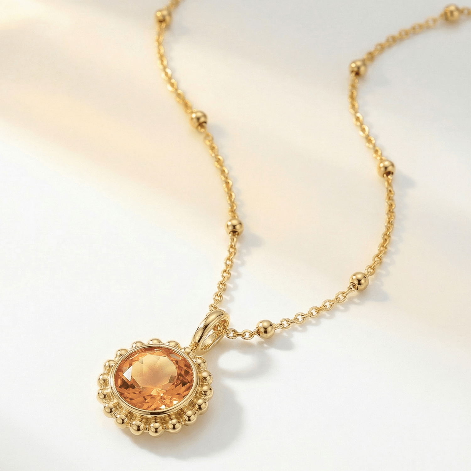 Sunburst necklace with a warm sunset-orange citrine and barnacle-textured bezel detail. Dainty ocean-inspired jewellery with coastal charm. Birthday Gifts